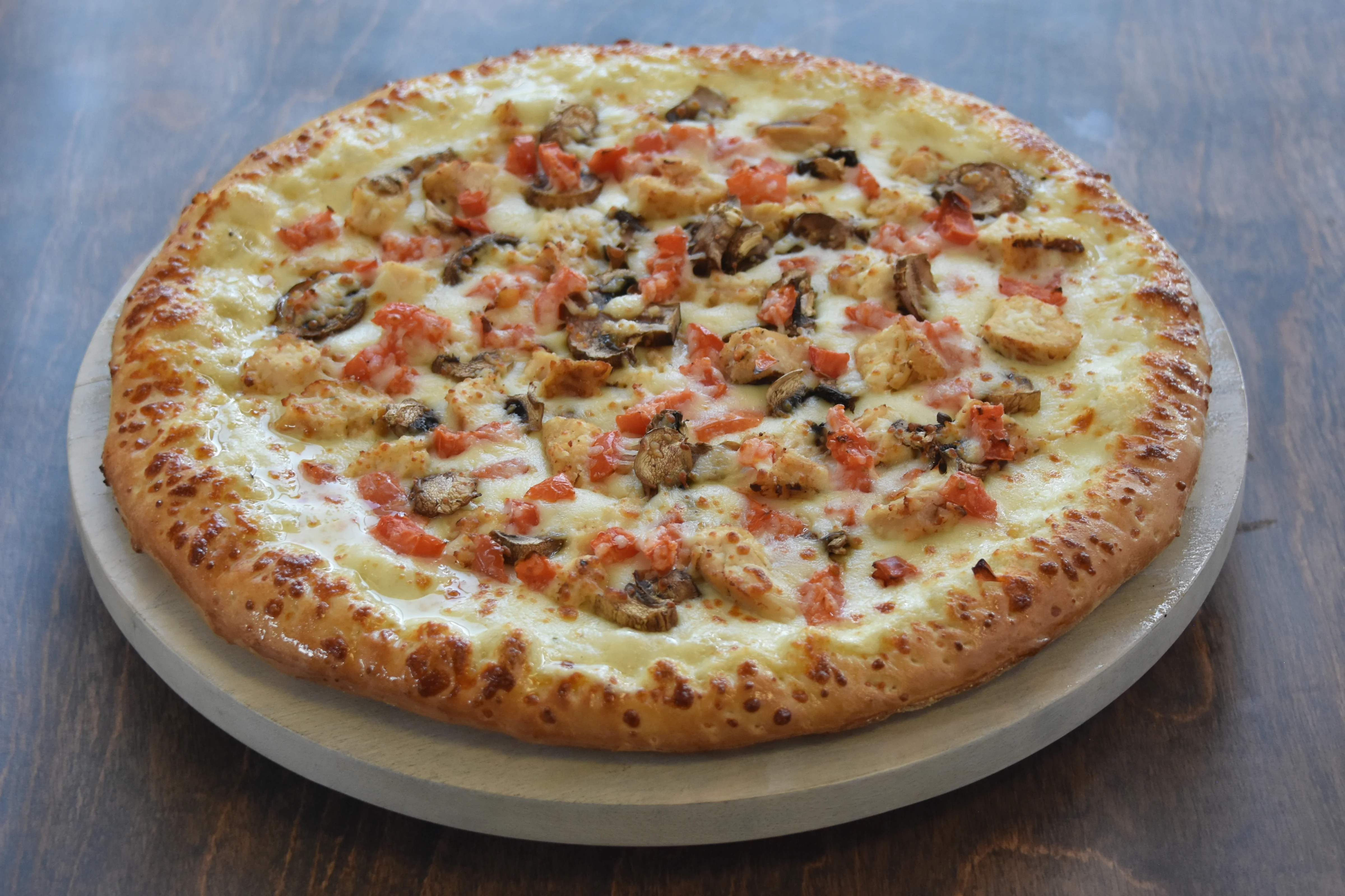 Delicious pizza with toppings on a wooden table