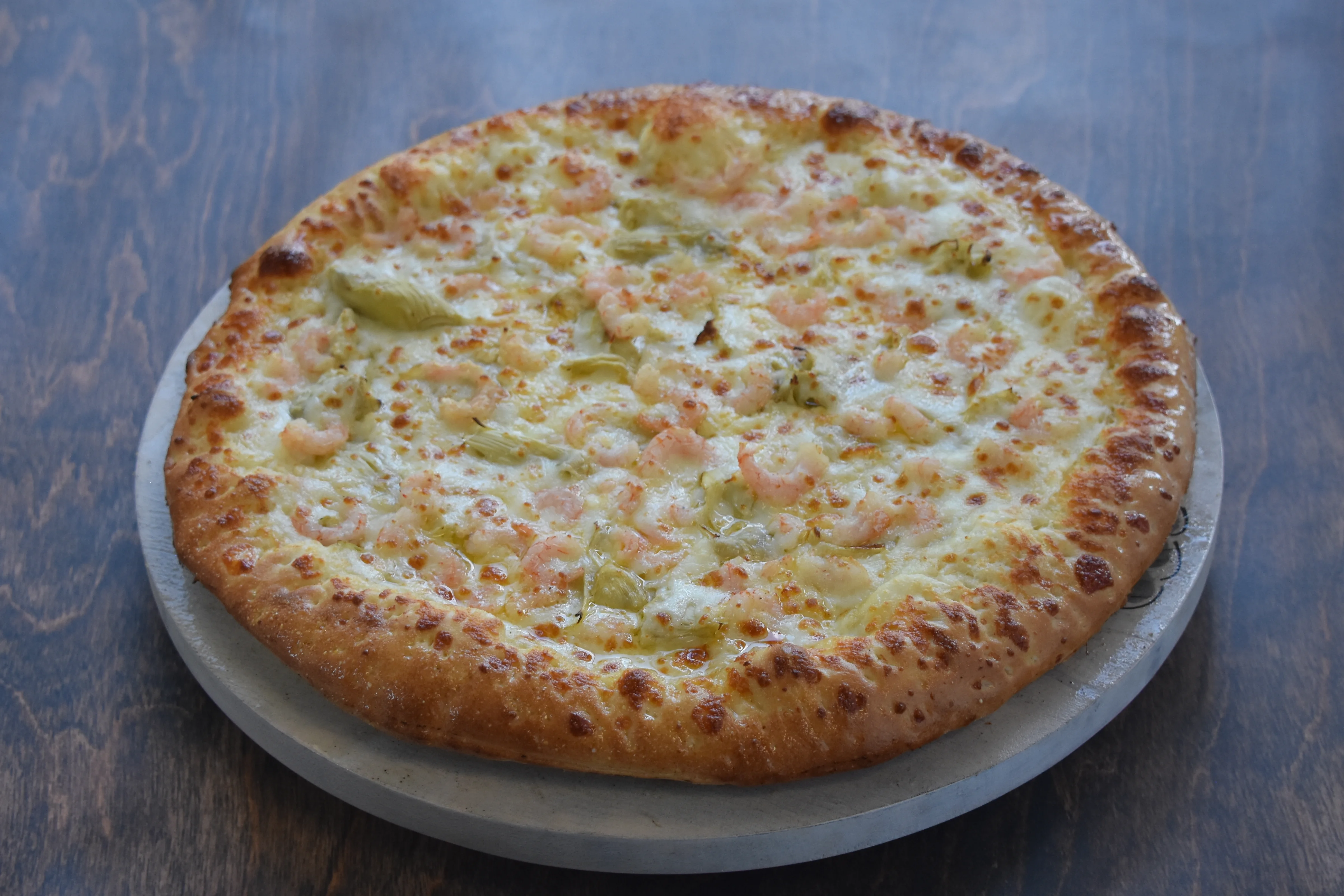 Delicious shrimp pizza on a wooden table